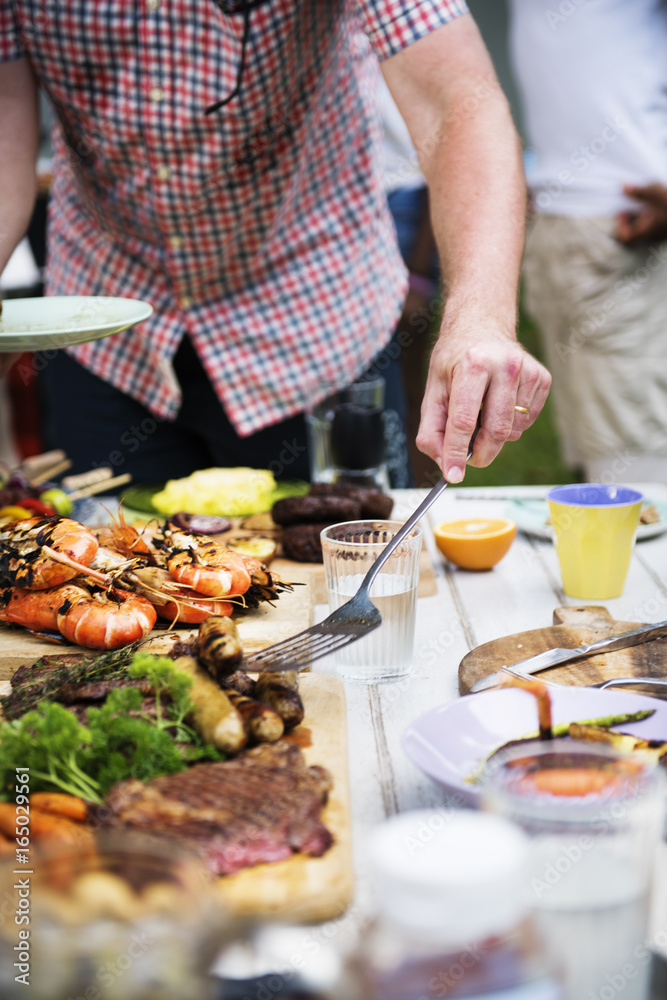 Closeup of man getting food from table