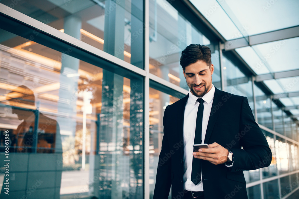 Business executive with mobile phone at airport