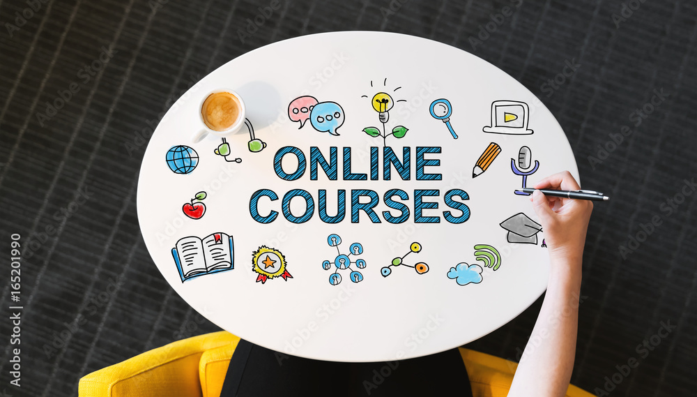 Online Courses text on a white table with persons hand