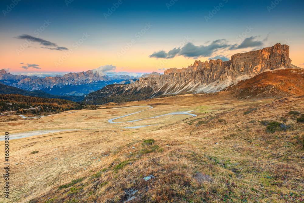 Majestic alpine pass with high peaks in background, Dolomites, Italy