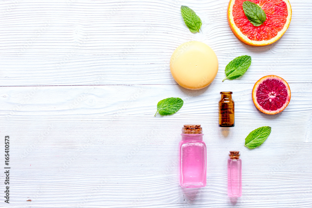 organic cosmetic with citrus on wooden background top view