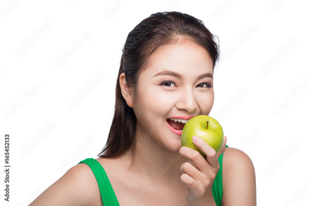 Young beautiful asian woman eating fresh green apple on white background