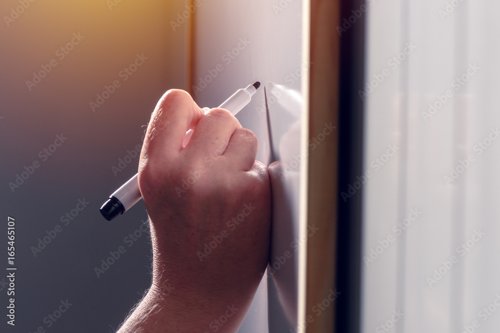 Female businessperson writing on whiteboard