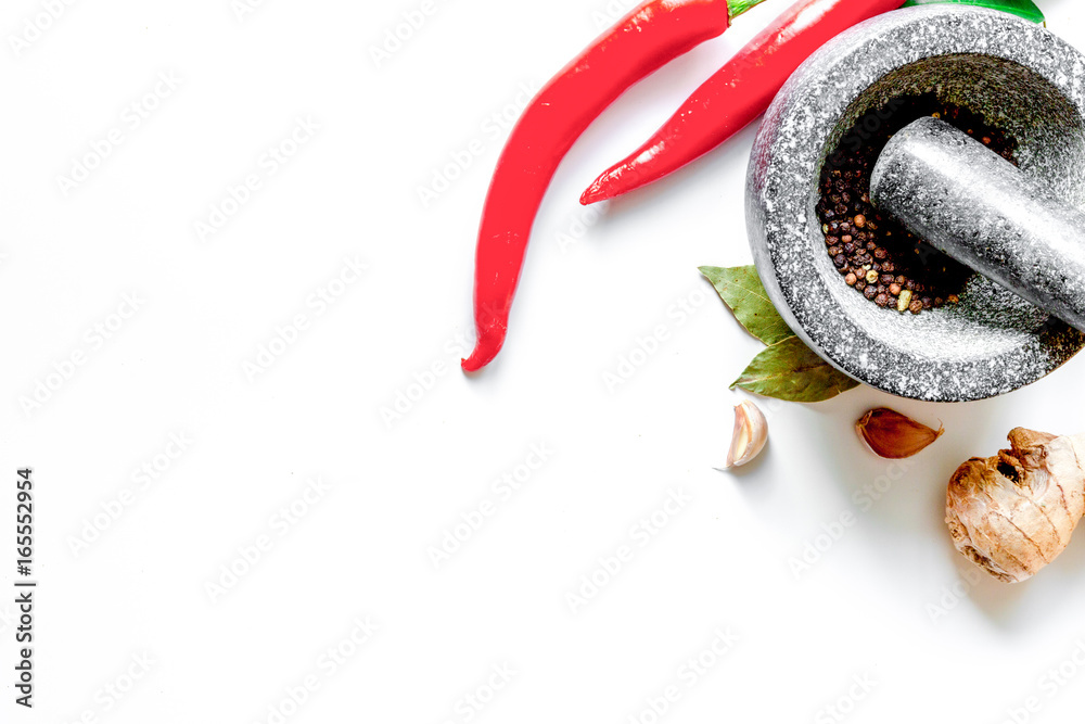 spices and stone mortar white background top view mock up