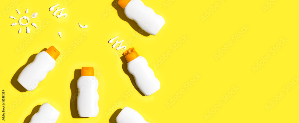 Sunscreen bottles arranged on a bright yellow background