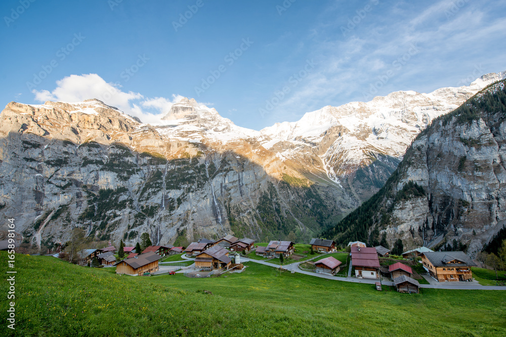 Farmhouse in village with swiss alps snow mountain in background in Grindelwald, Switzerland. Countr