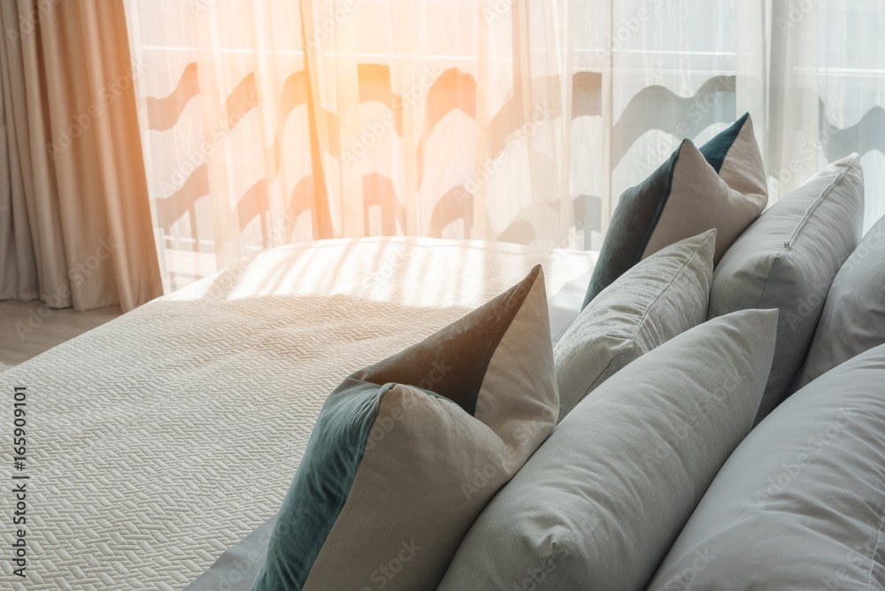 classic bedroom style with set of pillows and lamp on table side