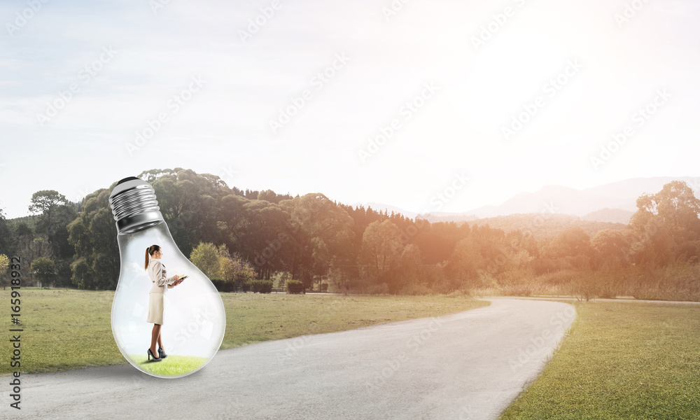 Businesswoman inside light bulb