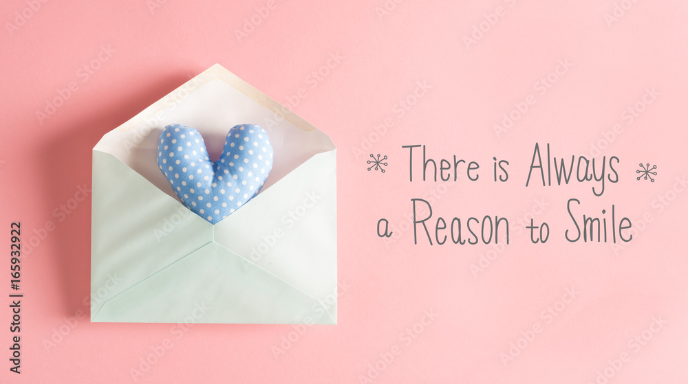 There Is Always A Reason To Smile message with a blue heart cushion in an envelope