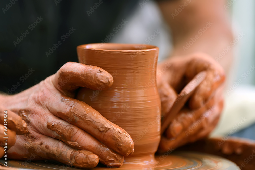 Potter making ceramic pot on the pottery wheel