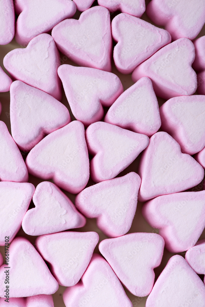 Valentines Day candy hearts marshmallows over green background