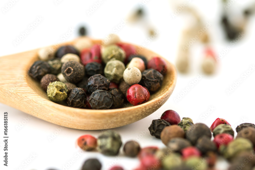 Close up mixed type of the peppercorns in wooden spoon