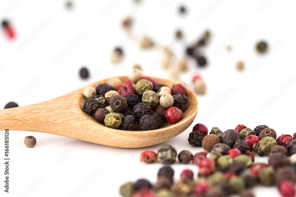 Close up mixed type of the peppercorns in wooden spoon