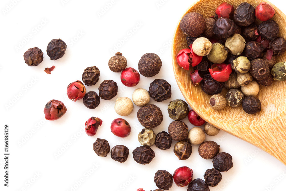 Close up mixed type of the peppercorns in wooden spoon , top view or overhead shot