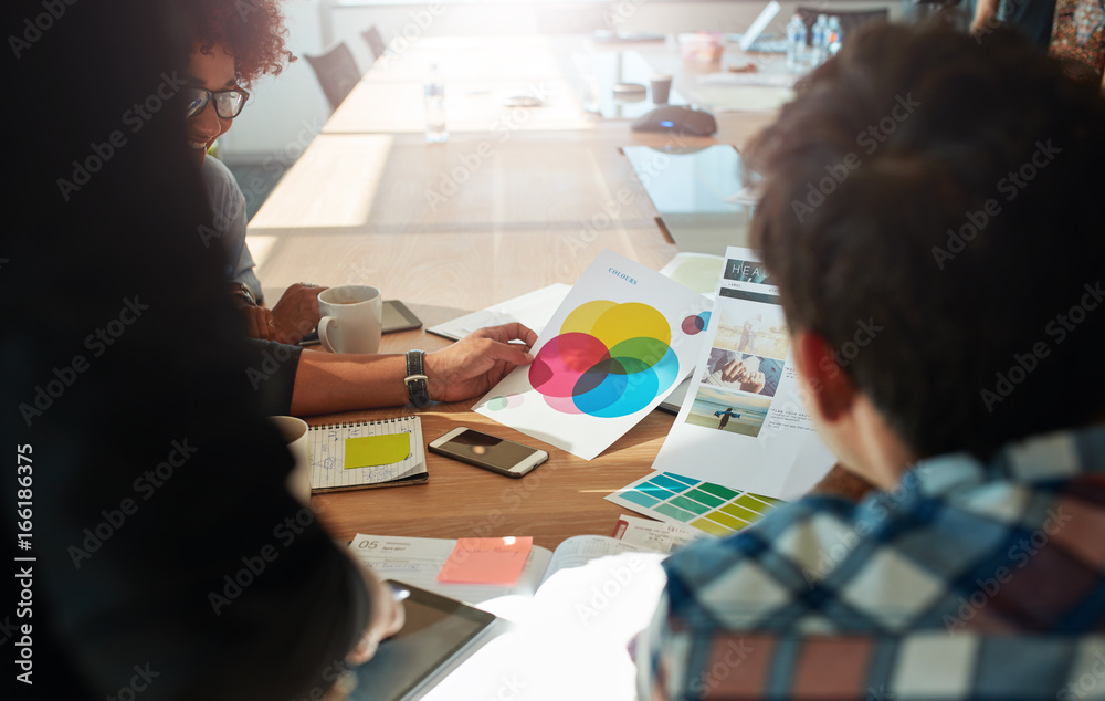 Team brainstorming in meeting room with color swatches