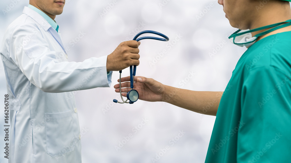 Doctor giving stethoscope to surgeon (Referral)