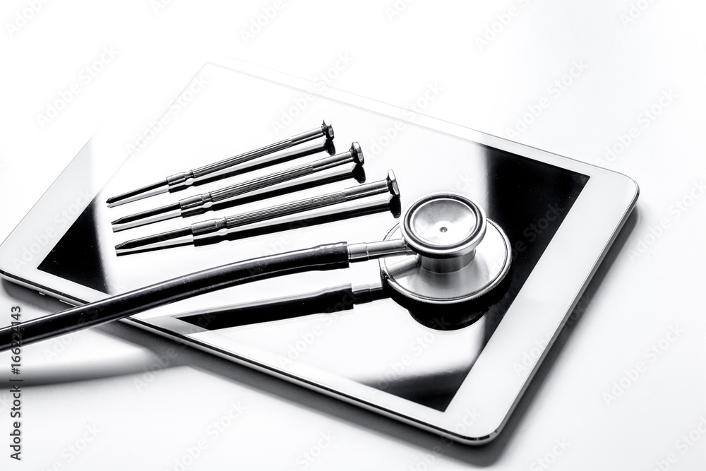 diagnostic of gadgets on white background with stethoscope