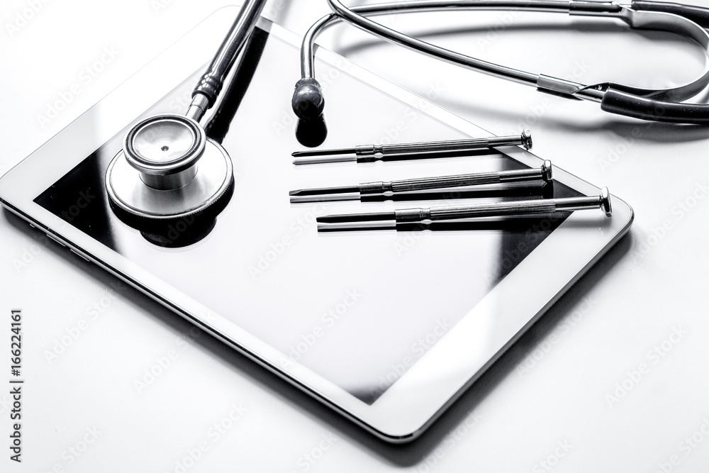 diagnostic of gadgets on white background with stethoscope