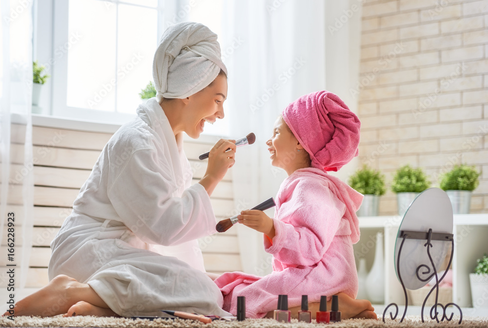 Mother and daughter are doing make up