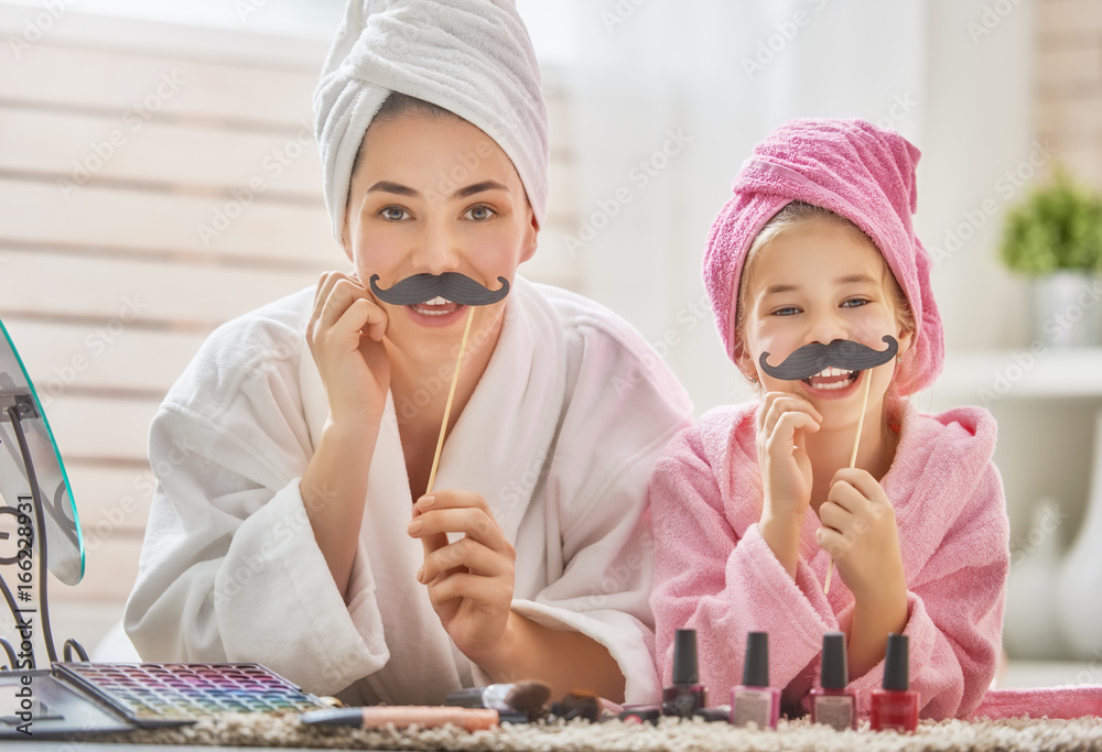 woman and girl with mustache on sticks