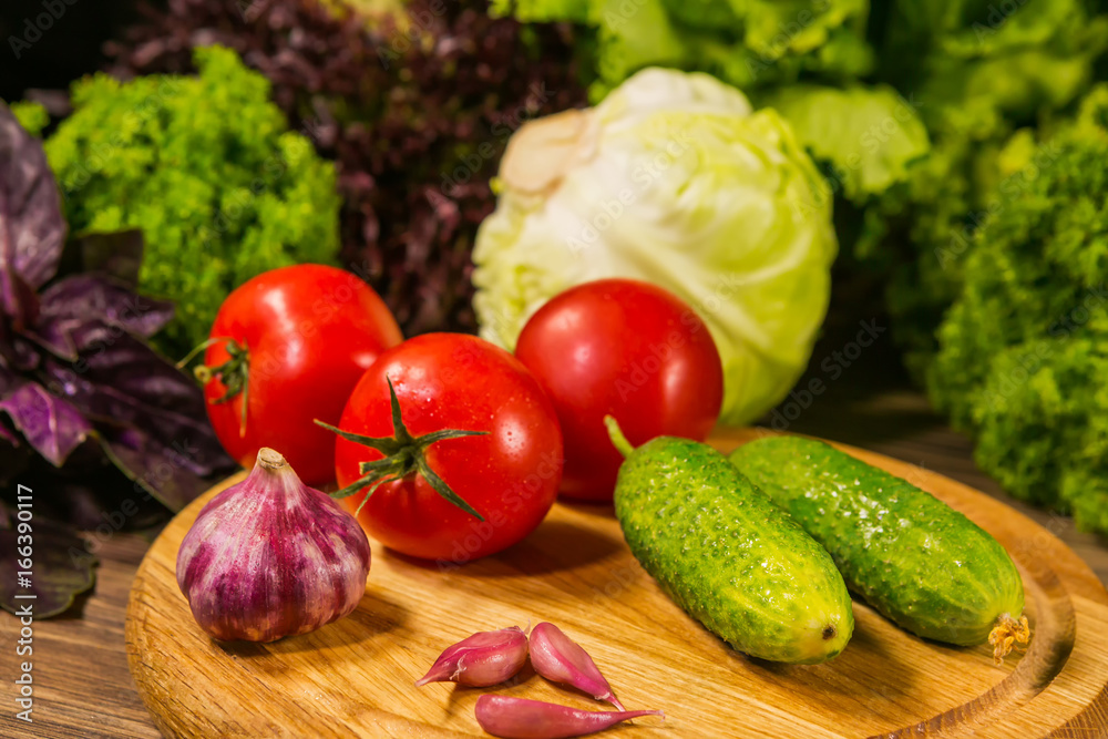 Fresh vegetables on a wooden board. Delicious vegetarian food