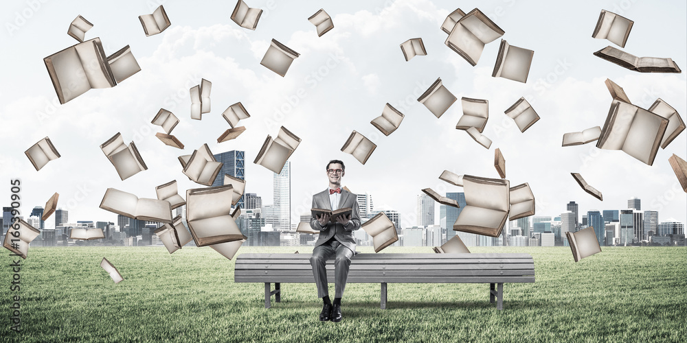 Young businessman or student studying the science in summer park