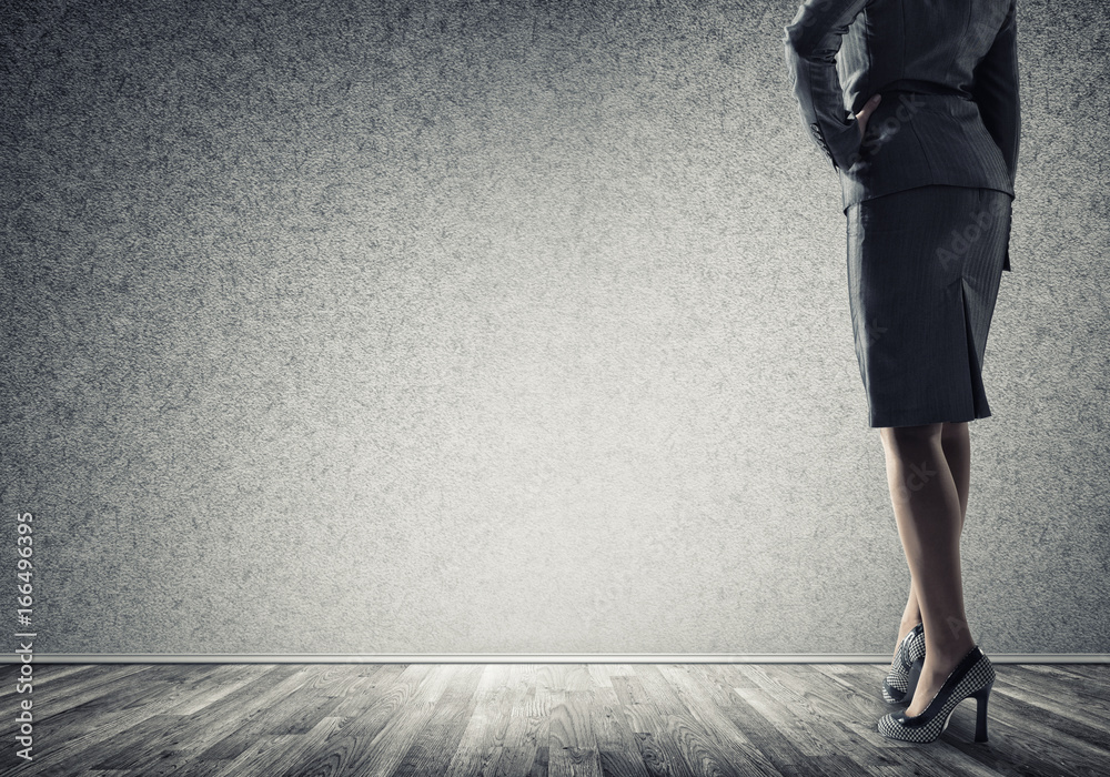 Businesswoman looking at wall