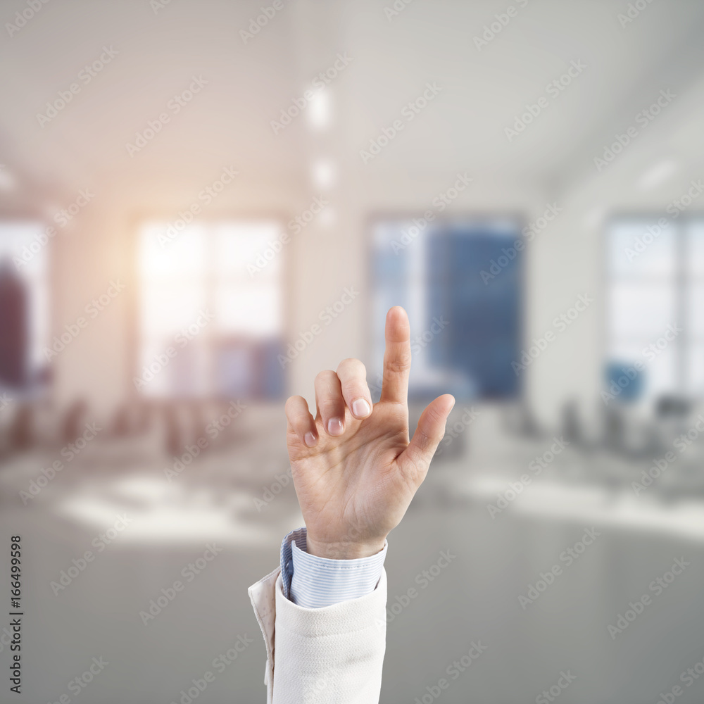 Choosing gesture of businessperson in elegant modern interior in sunshine light