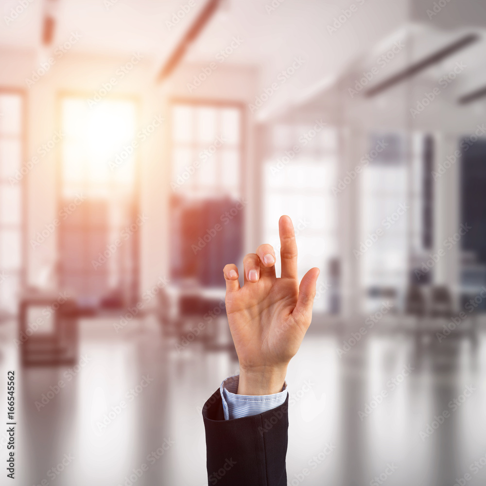 Choosing gesture of businessperson in elegant modern interior in sunshine light