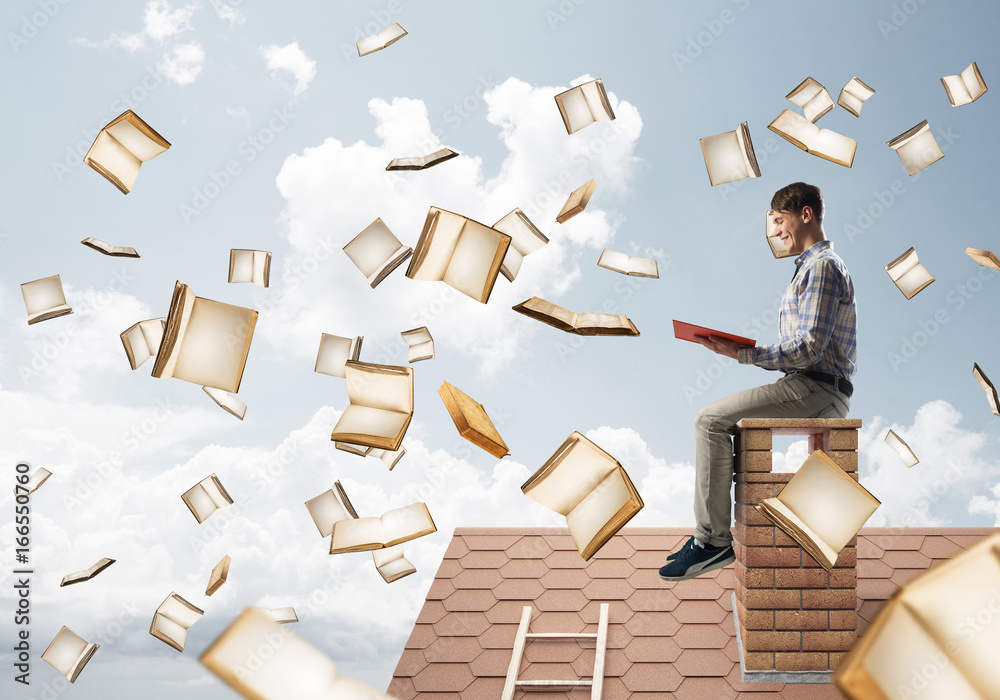 Man reading book and many of them flying in air