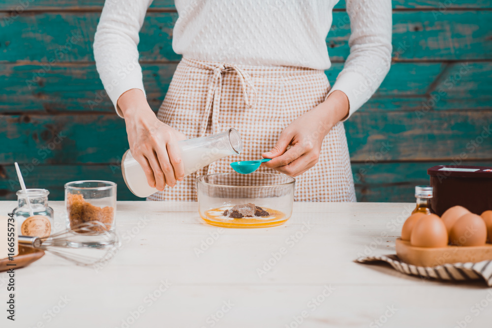 House wife wearing apron making. Steps of making cooking chocolate cake.