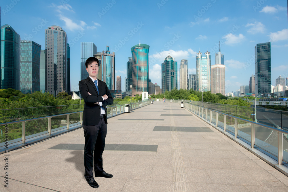 Asian Businessman standing with his arms crossed with Shanghai lujiazui finance and business distric