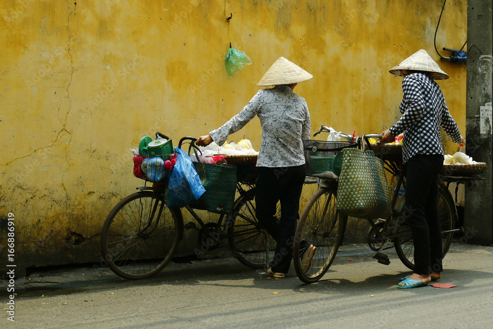 street seller  with bicycle in the street of hanoi