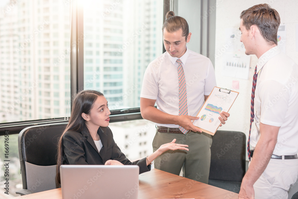 Young manager presenting whiteboard to his colleagues about financial growth