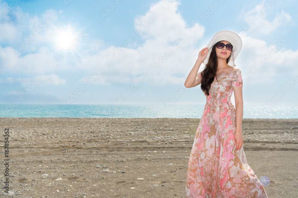 attractive woman standing on the ocean beach