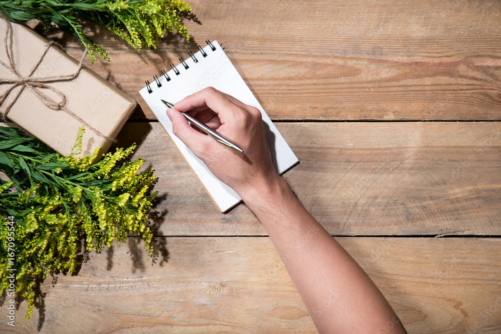 Christmas decorated gift box over wooden background. View from above