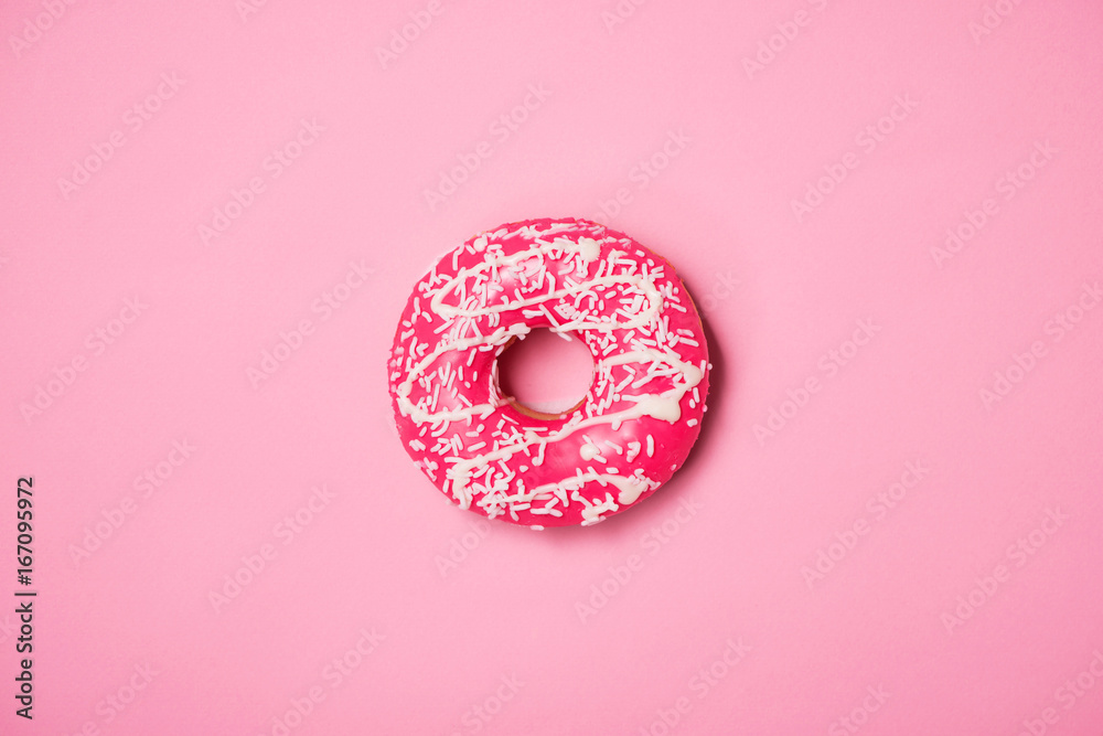 Donuts with icing on pastel pink background. Sweet donuts.