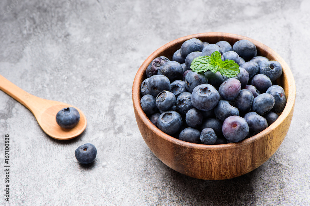 blueberry with vanilla mint in a wooden bowl on stone background ,top view
