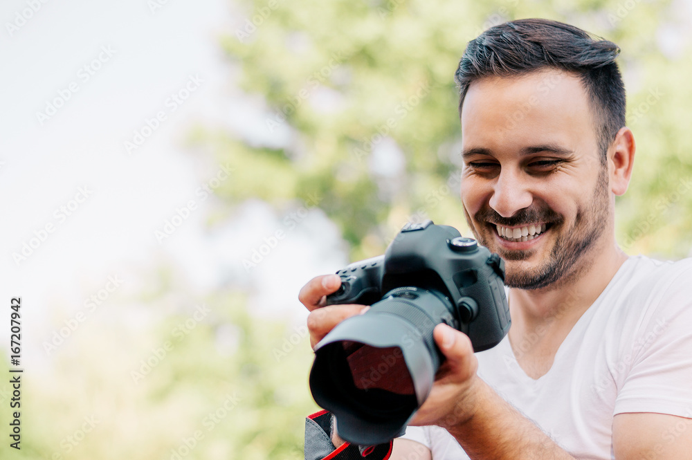 Man looking at photos he taken