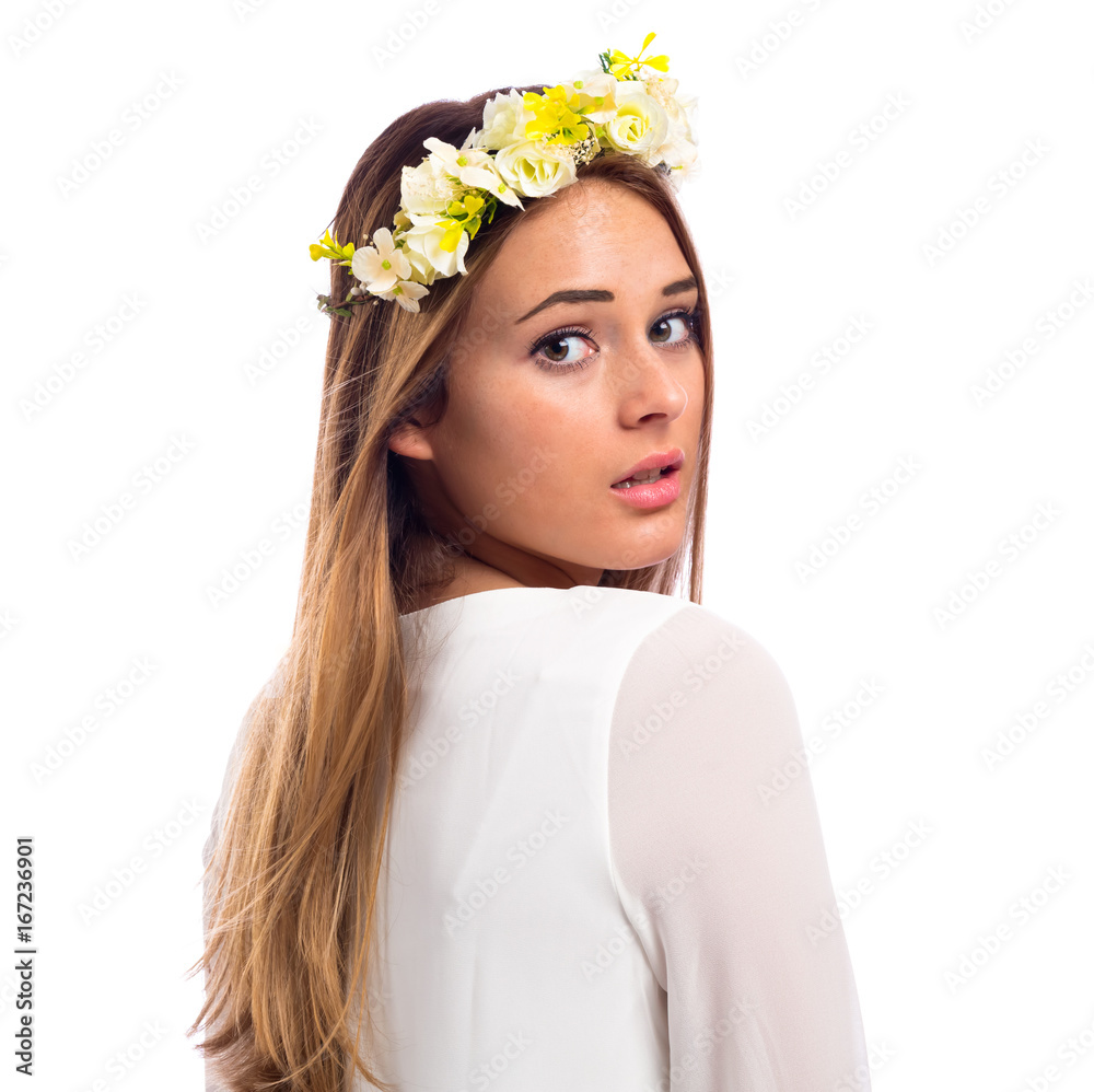 Beautiful young woman with a flower garland and a white dress isolated on a white background