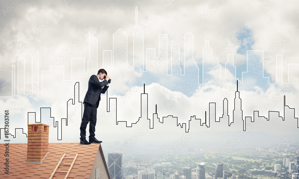 Businessman standing on roof and looking in binoculars. Mixed me