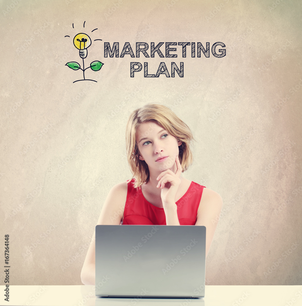 Marketing Plan concept with young woman working on a laptop 