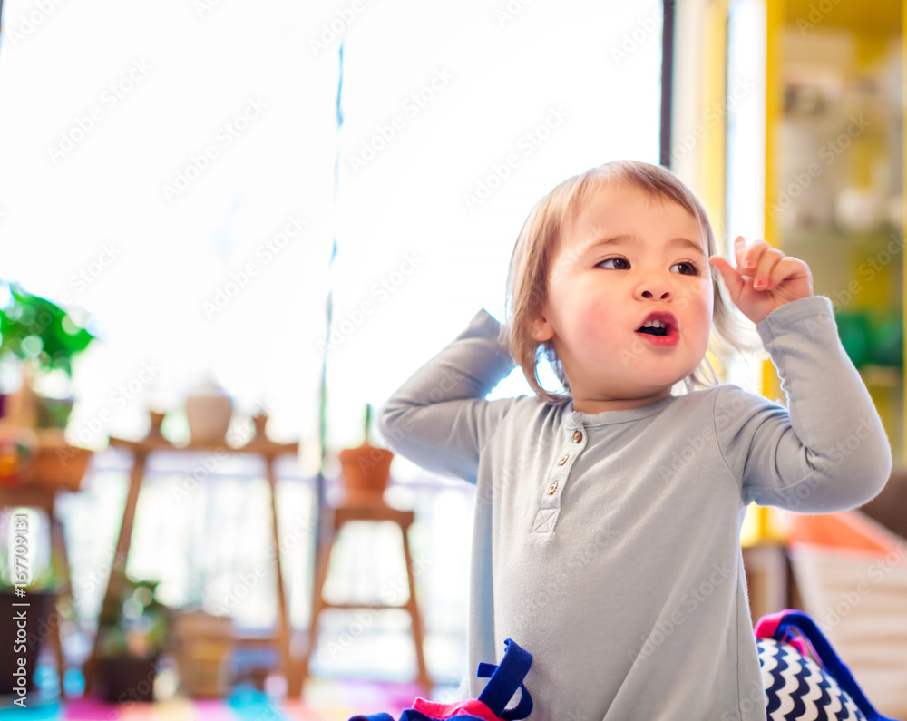 家里穿着蓝色连衣裙的幼童