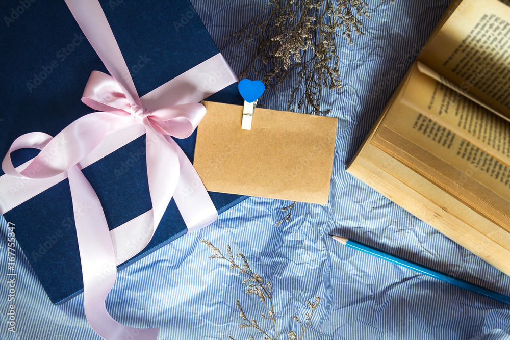 Dark blue gift box with  ribbon decoration with book and flower on polka blue paper , Happy Fathers