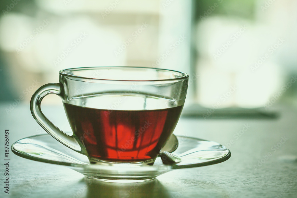 Close up the warm black tea cup on the wooden table in living room , relax with tea time concept