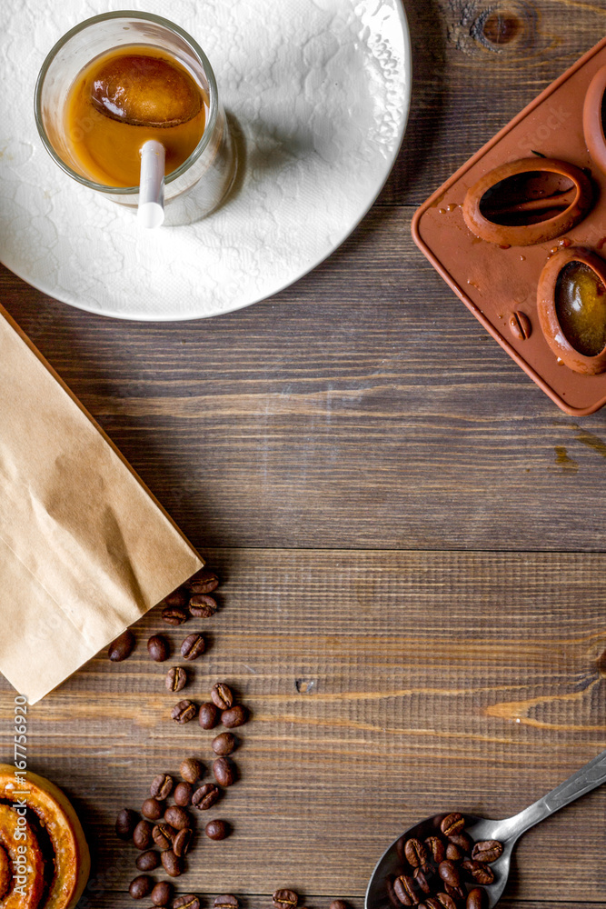 coffee with ice in glass on wooden background top view