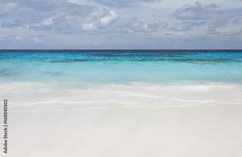 White beach sand and beautiful blue sea and sky