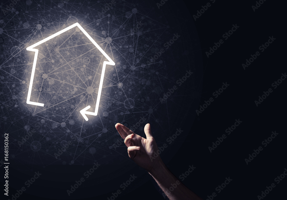 Conceptual image with hand pointing at house or main page icon o