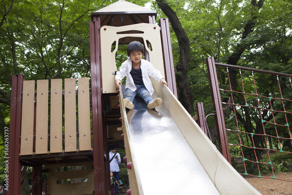 A boy descending the slide