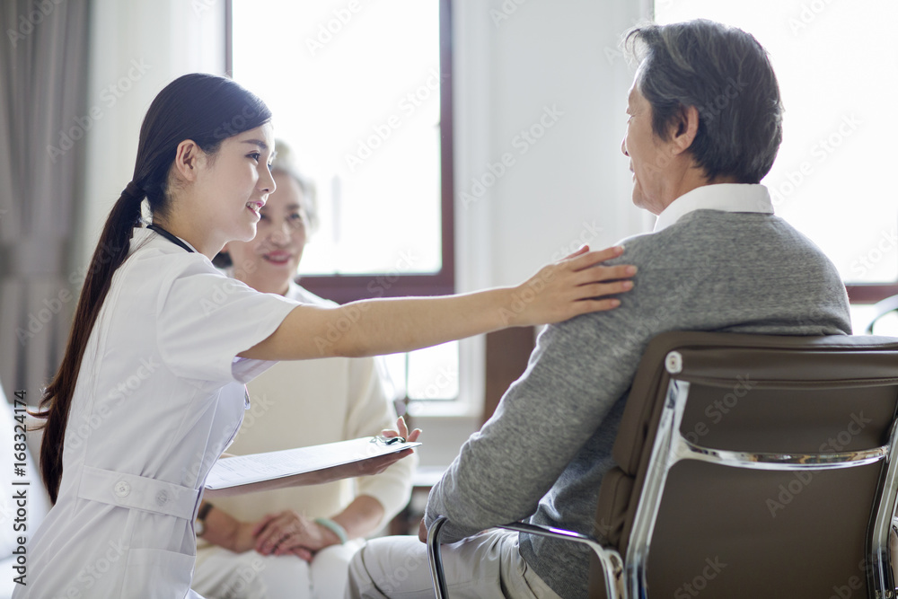 Nursing assistant taking care of senior man